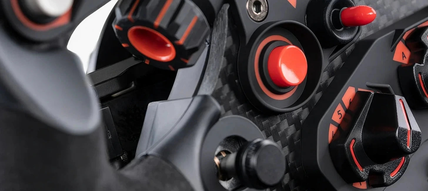 Close-up of a steering wheel with red and black controls