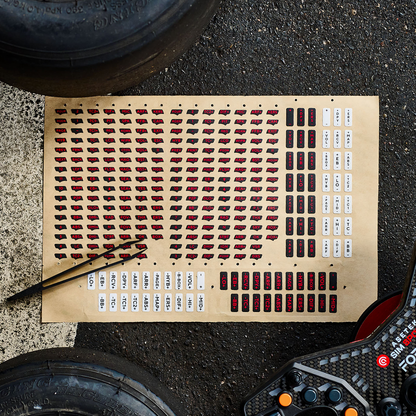 Angled view of the Asetek SimSports Red Sticker Sheet for button boxes and steering wheels